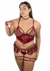 Woman wearing a red lace lingerie set on a white background