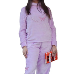 Woman in cozy purple pajama set from the "Women's Cozy Pajama Set" collection reading a book