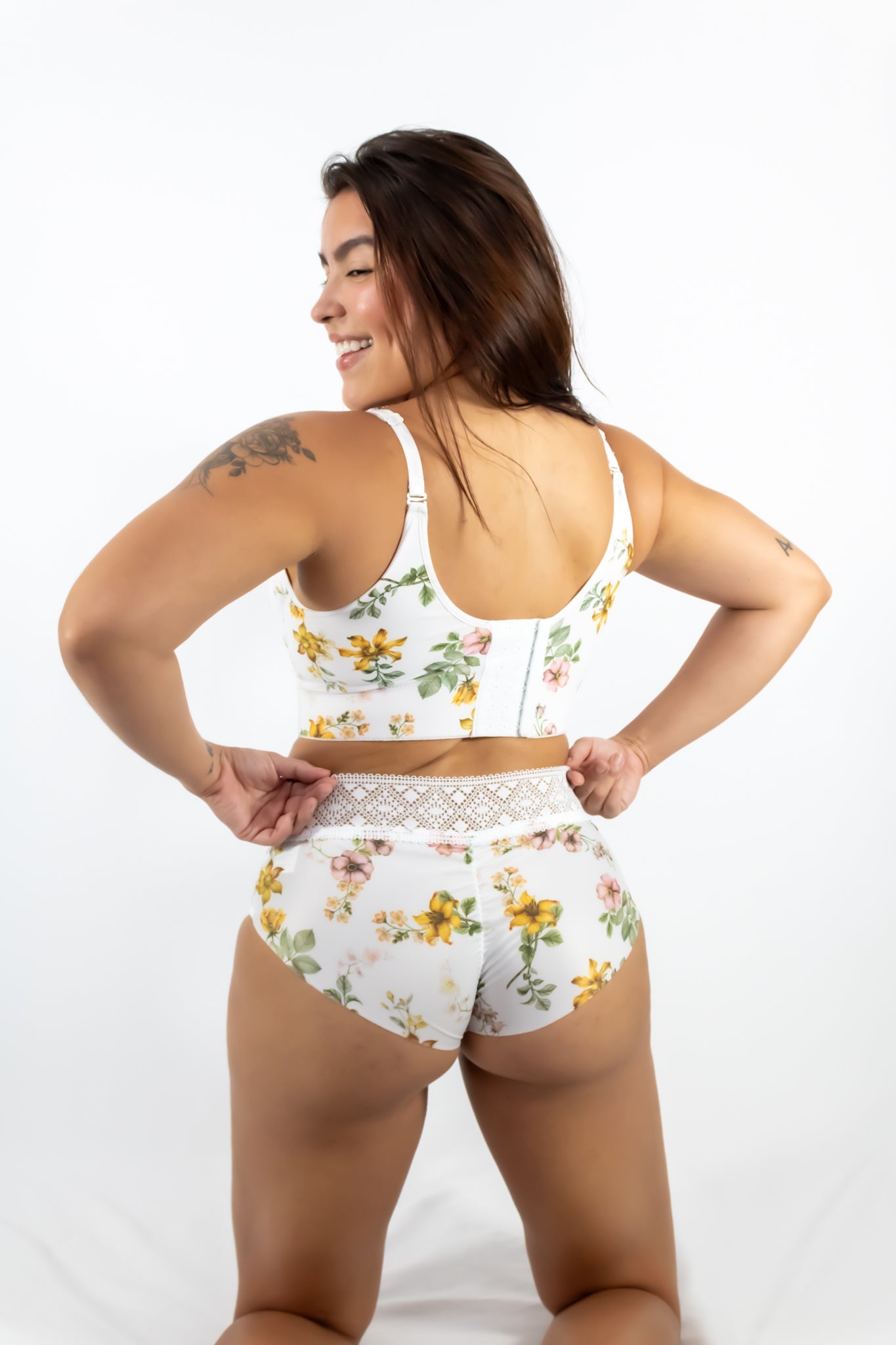 Woman wearing a floral two-piece outfit on a white background