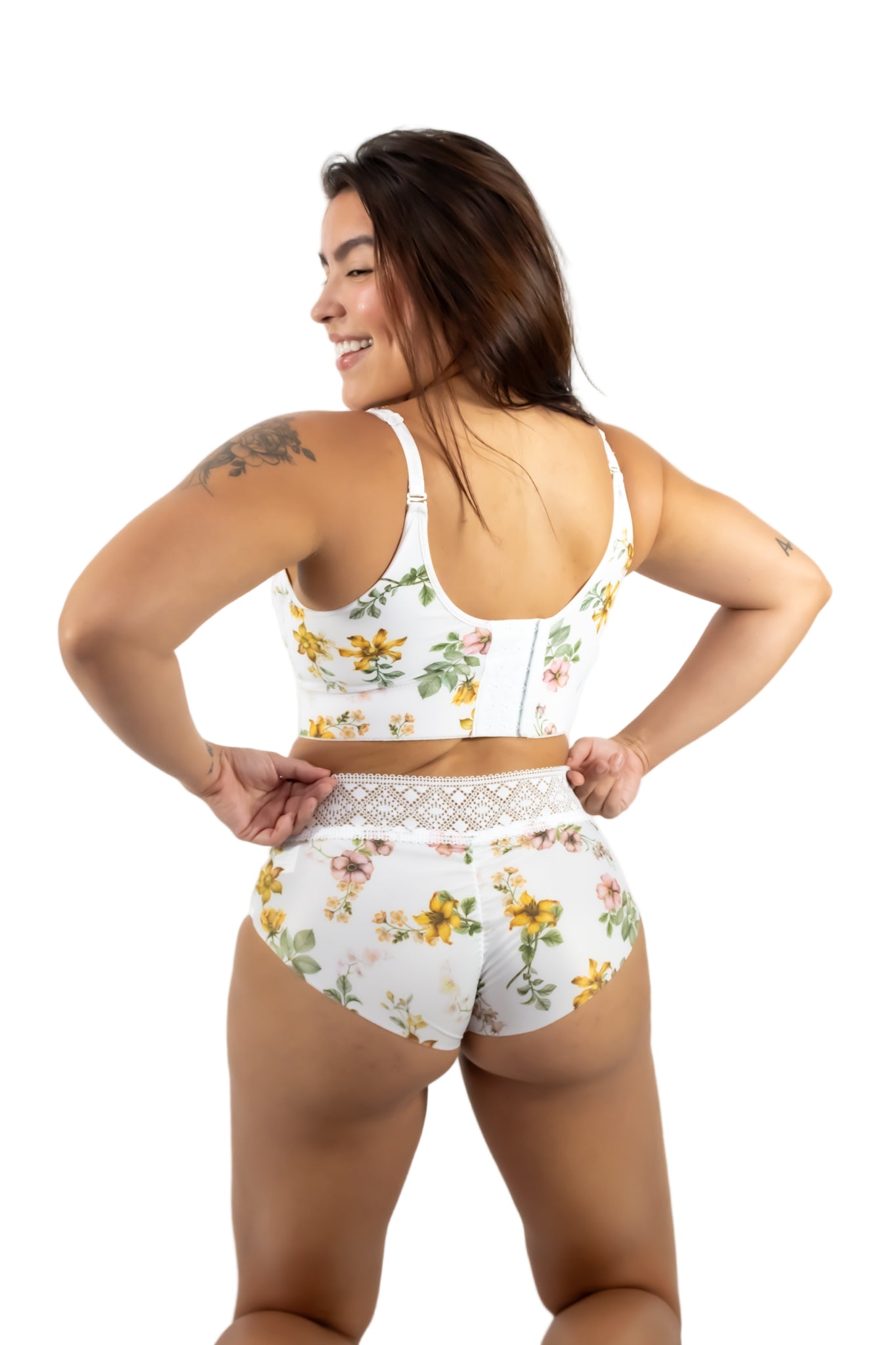 Woman wearing a floral two-piece outfit on a white background