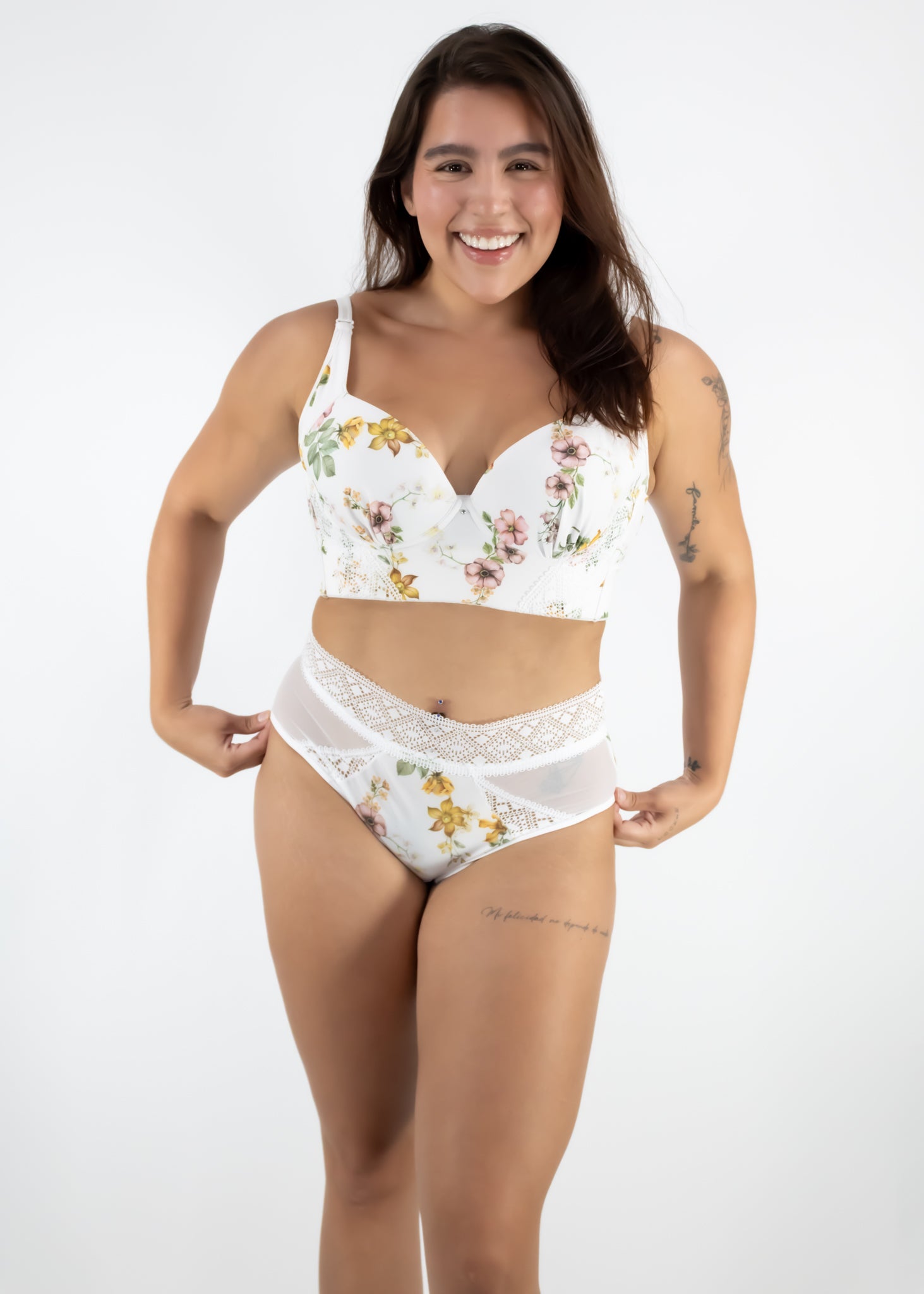 Woman wearing a floral white lingerie set on a plain background