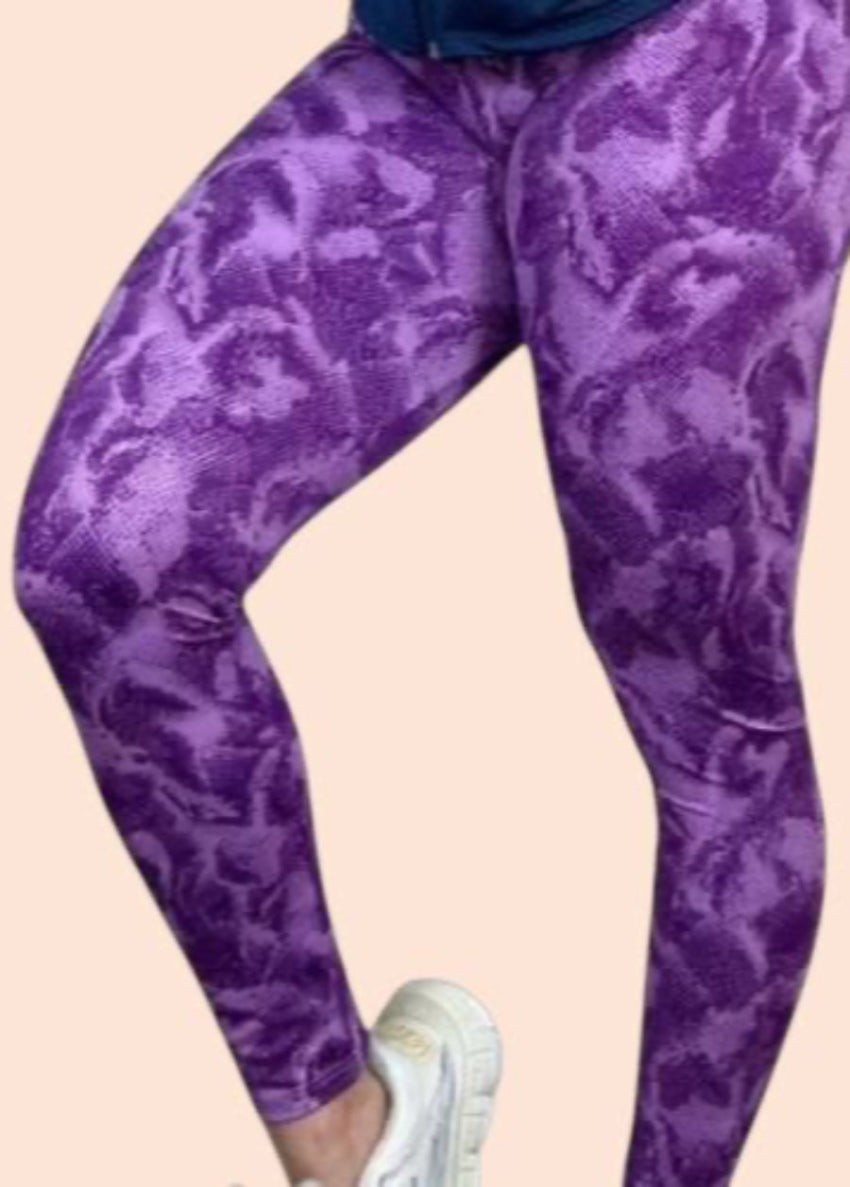 Purple patterned leggings worn by a person on a beige background