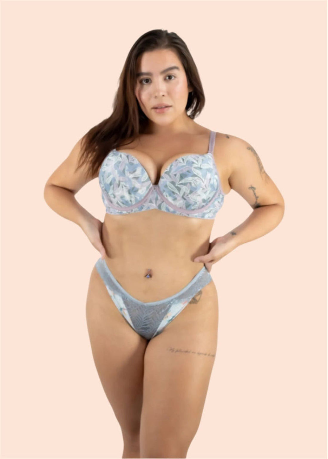 Woman wearing a floral bra and denim underwear set on a beige background