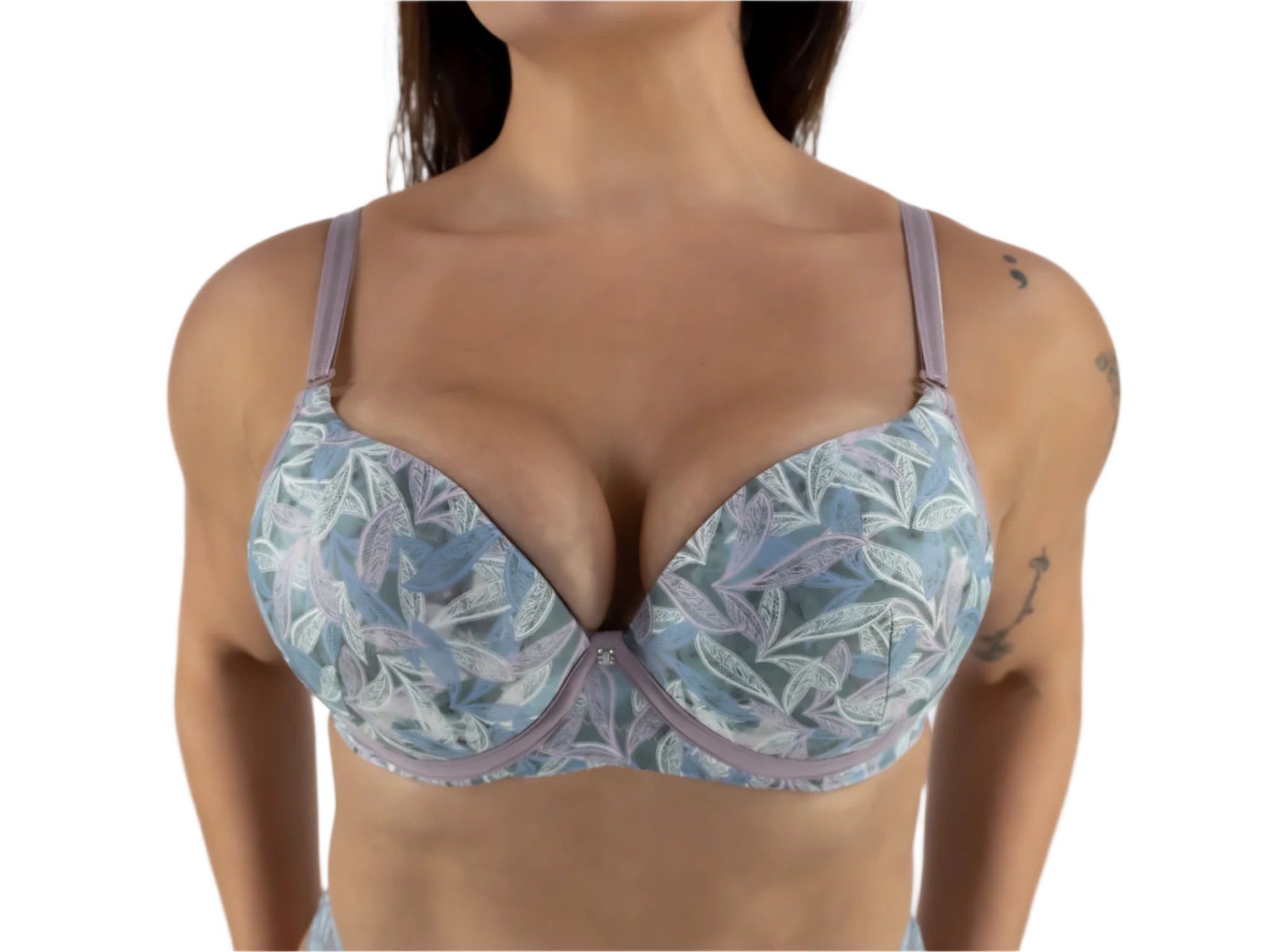 Woman wearing a floral-patterned bra against a plain background