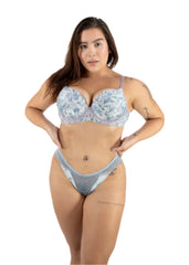Woman wearing a floral bra and gray underwear set on a white background