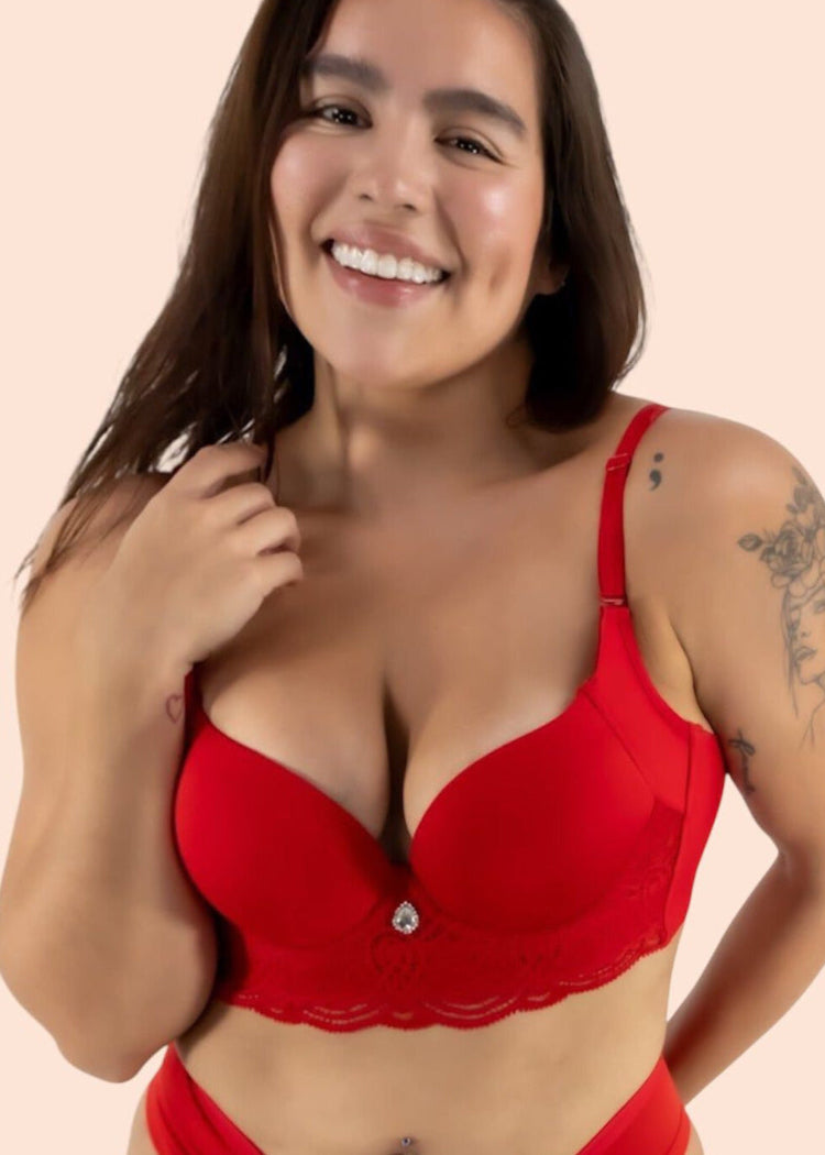 Woman wearing a red bra and panties set on a beige background