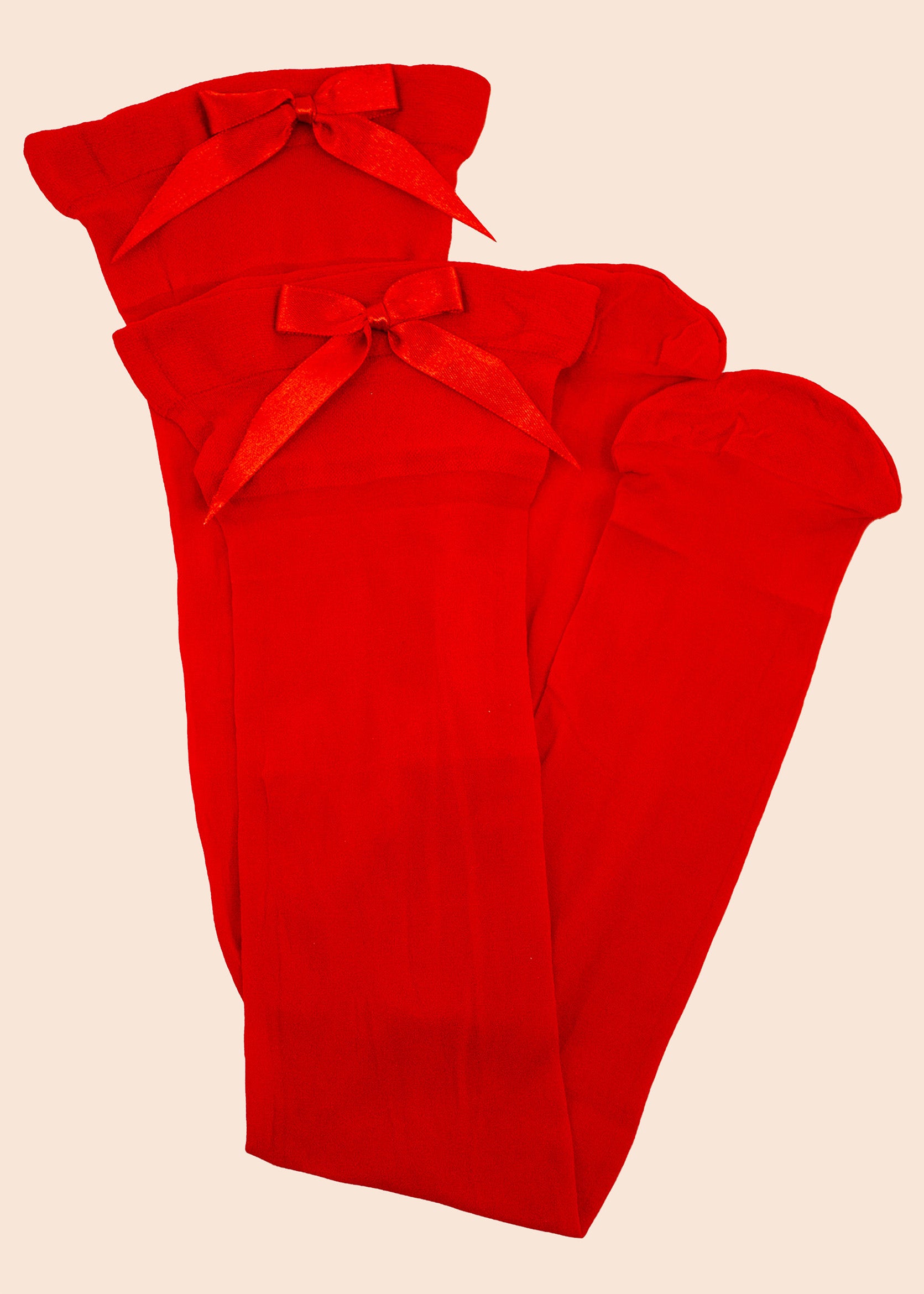 Red fabric with a bow on a beige background