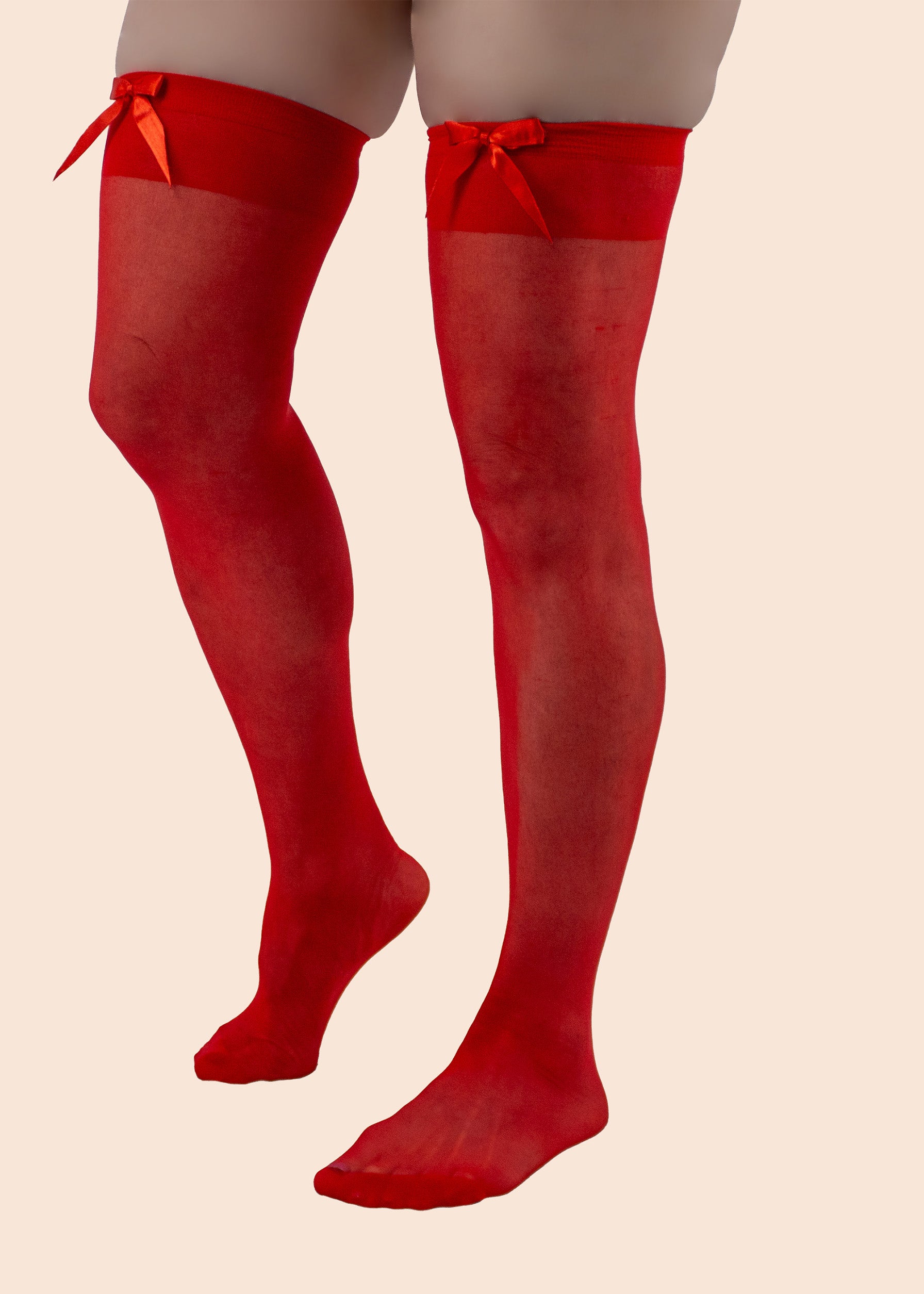 Red knee-high socks with bows on a beige background