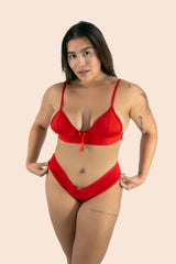 Woman wearing a red bikini against a beige background