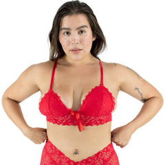 Woman wearing a red lace lingerie set on a white background