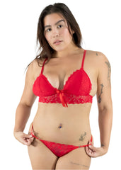 Woman wearing a red lace lingerie set on a white background