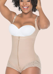 Woman wearing a beige shapewear garment with a white bra on a beige background
