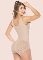 Woman wearing a beige shapewear bodysuit on a beige background