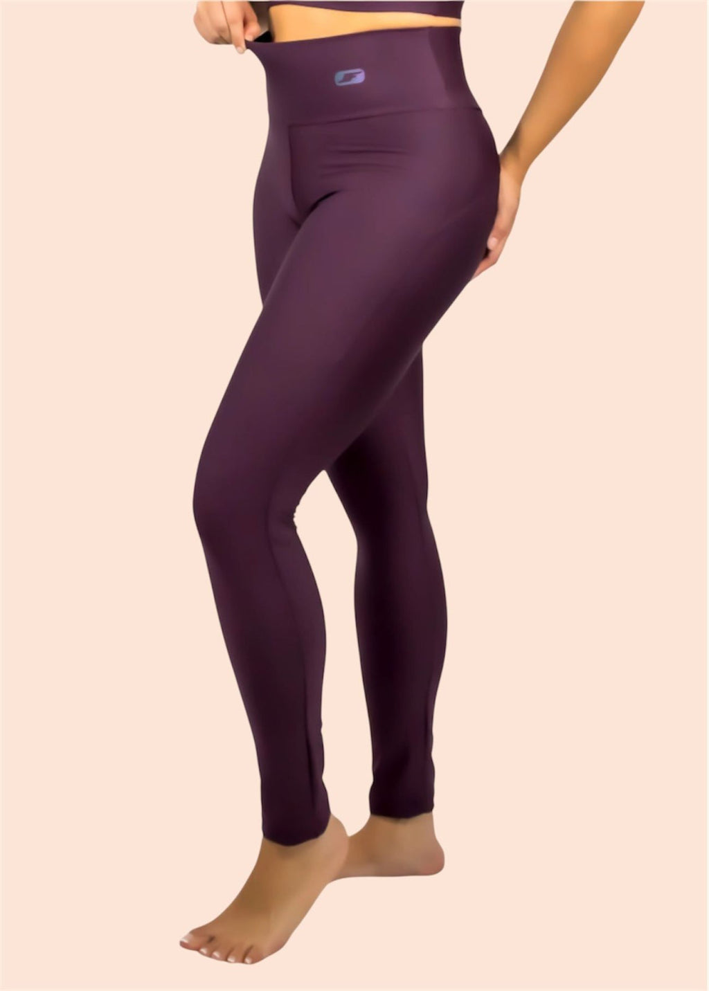 Purple leggings worn by a person on a beige background