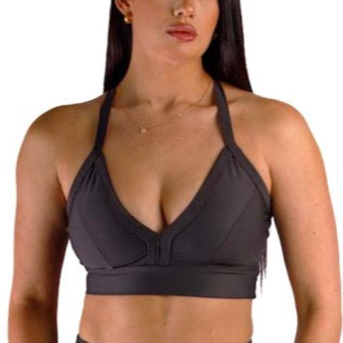 Sporty woman showcasing a black sportswear bra from the front