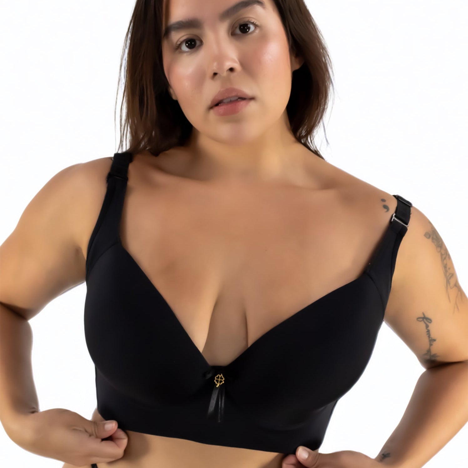Woman wearing a black bikini top against a white background