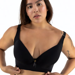 Woman wearing a black bikini top against a white background