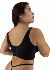 Woman wearing a black sports bra on a white background