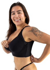 Woman wearing a black bikini against a white background