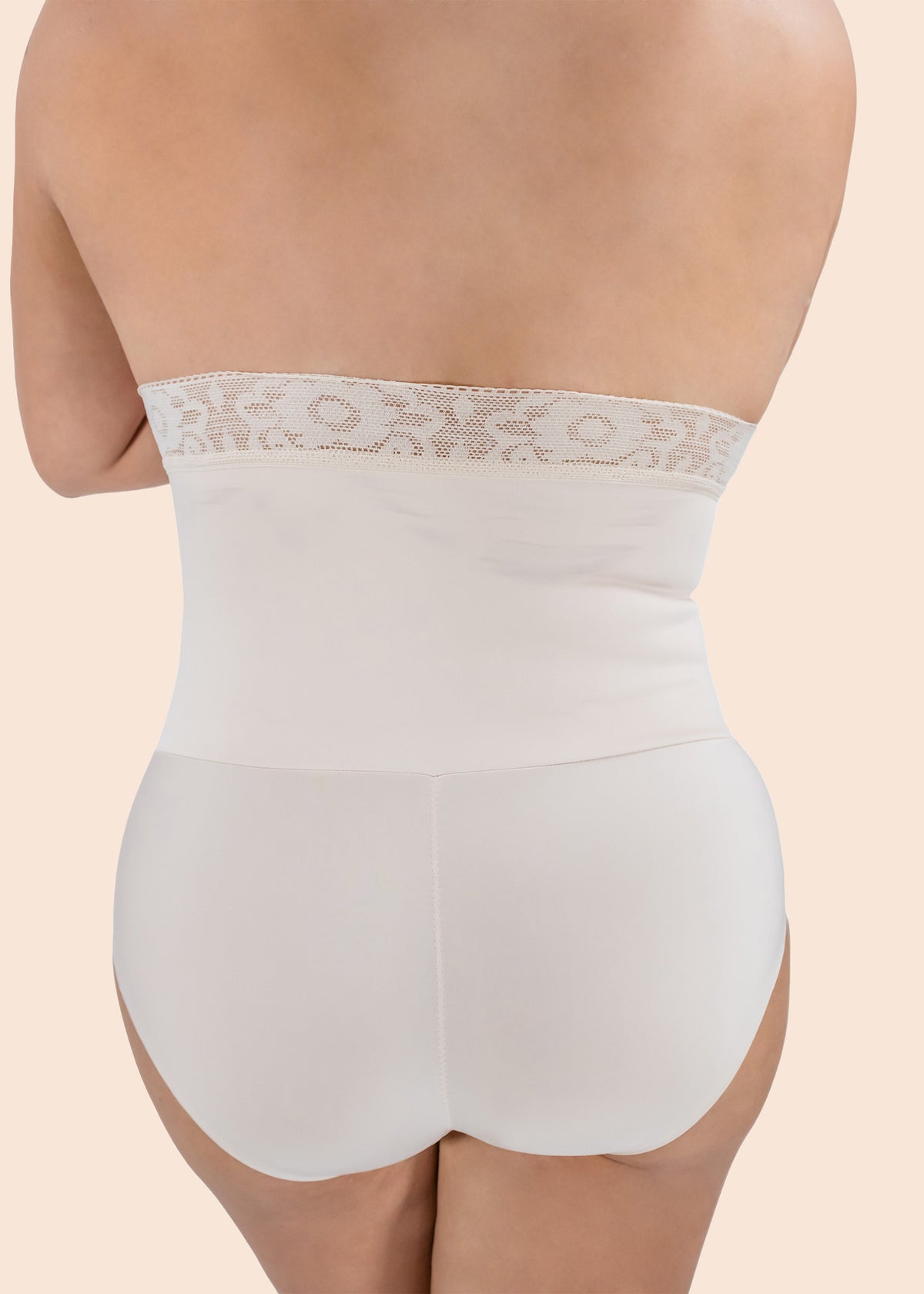 White shapewear with lace waistband on a beige background