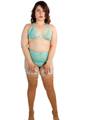 Woman wearing a teal lingerie set with stockings on a white background