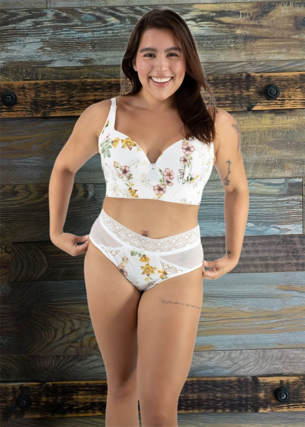 Woman wearing a white floral bikini set against a wooden background