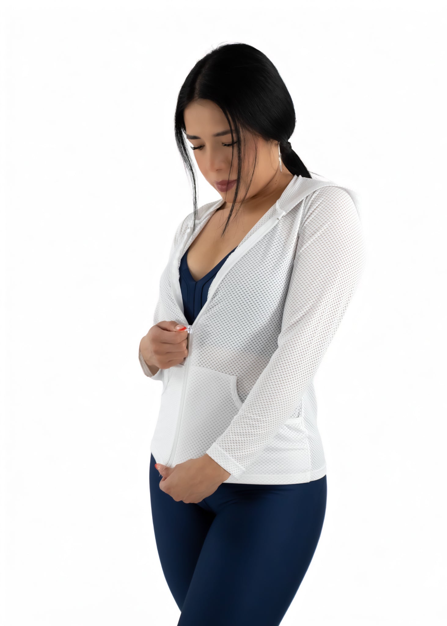 Woman wearing a white mesh cardigan over a blue top on a white background
