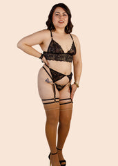 Woman wearing black lace lingerie on a beige background